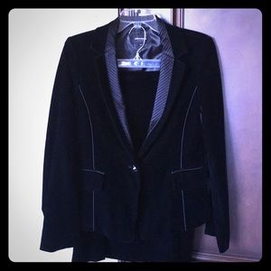 A black velvet jacket and skirt suit